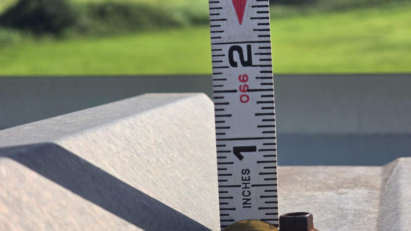Tape measure documenting metal roof rib height