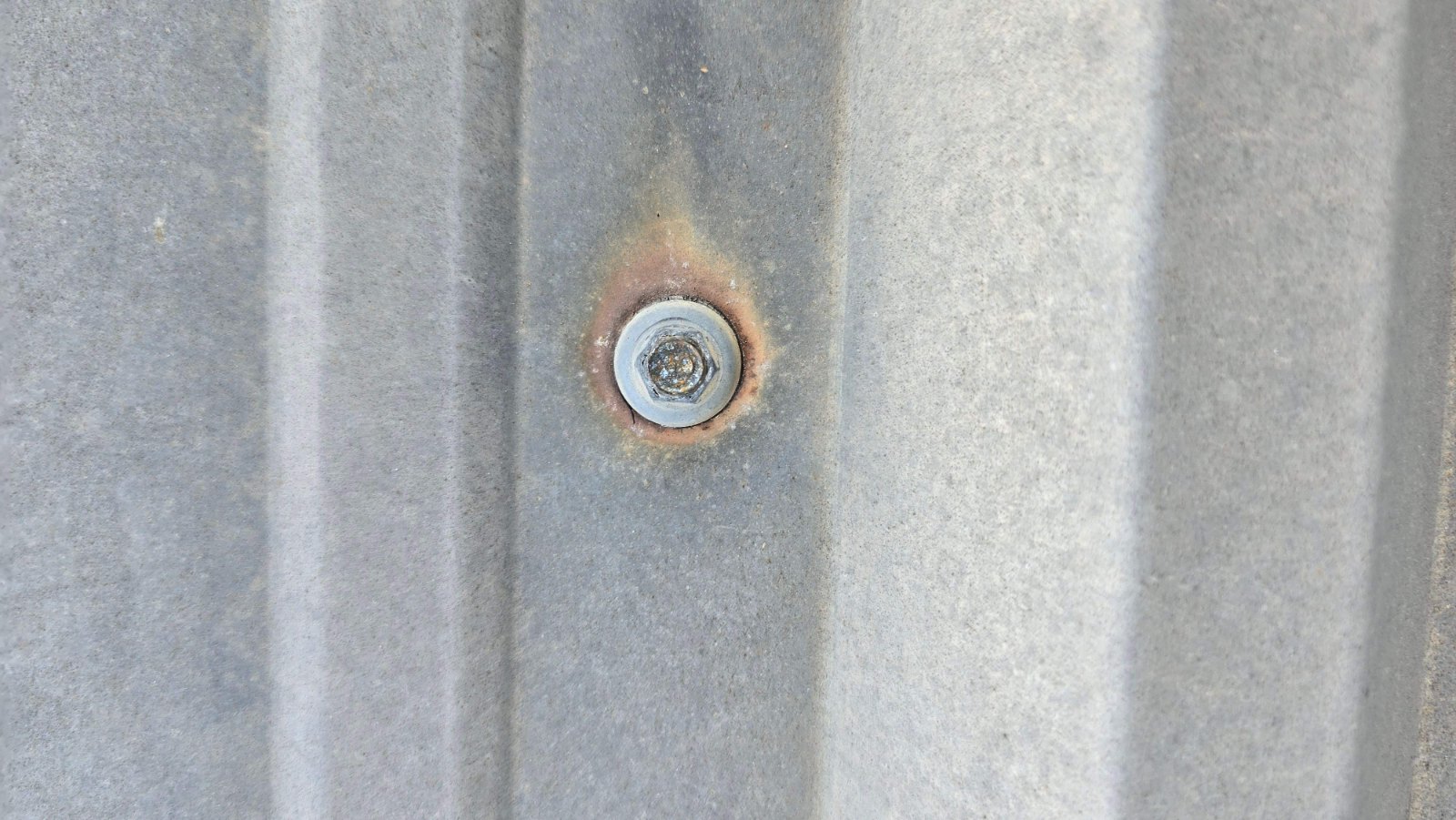 Rusted fastener on a metal roof panel